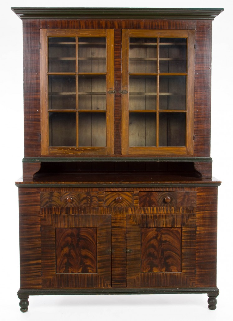 This Pennsylvania paint-decorated step-back cupboard, circa 1830, in its original paint-decorated surface, brought $12,650. Jeffrey S. Evans & Associates image