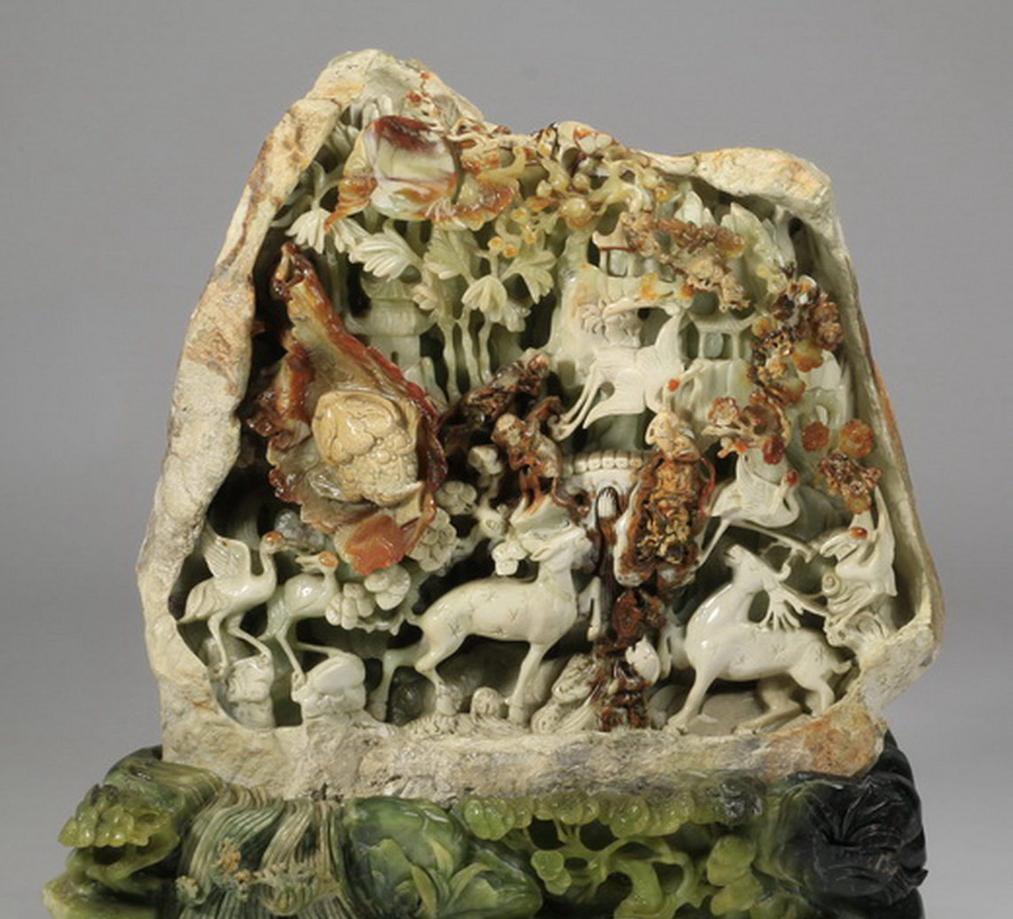 Oversized carved jade sculpture depicting animal life in a landscape setting, 35 inches high. Great Gatsby’s Auction Gallery image