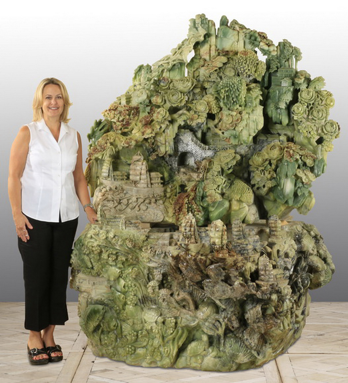 Monumental Chinese carved jade sculpture, 83 inches tall, finely detailed, with the upper portion depicting a mountainous landscape. Great Gatsby’s Auction Gallery image