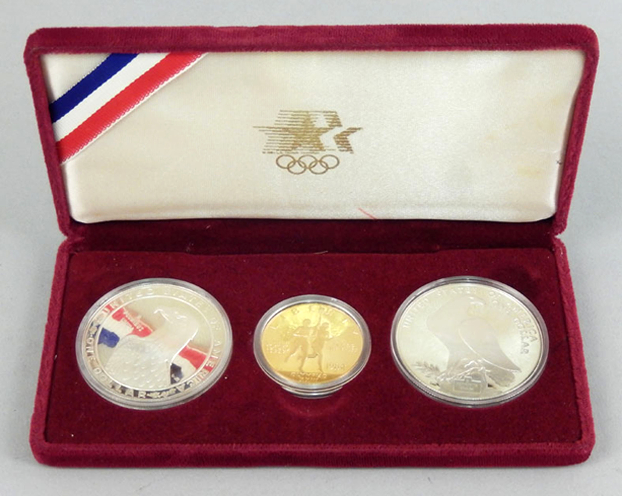 1984 gold US Olympics coin set consisting of a US $10 gold coin and two silver dollars. Image: Stephenson’s Auctioneers