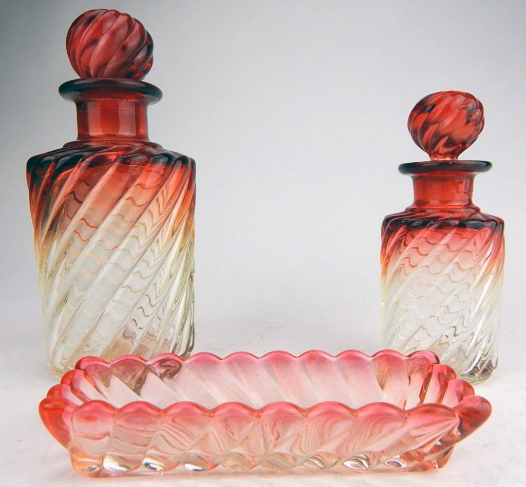 Baccarat glass ‘Rose Tiente’ bottles and dish. Bottles measure 6in. and 4 1/2in. high. Estimate $200-$300. Don Presley Auctions image