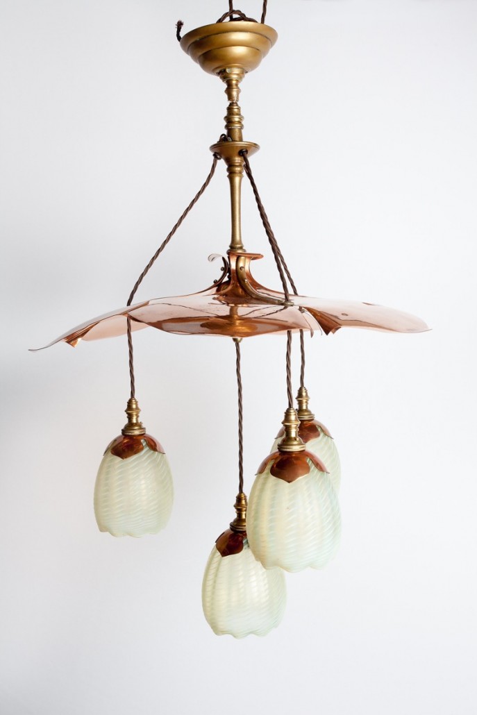 A Benson copper and brass ceiling light (left) with copper petal shades forming a flower head, the striped and fluted glass shades by James Powell & Co. It sold at Mallams for £8,200. Photo Clare Borg-Cook