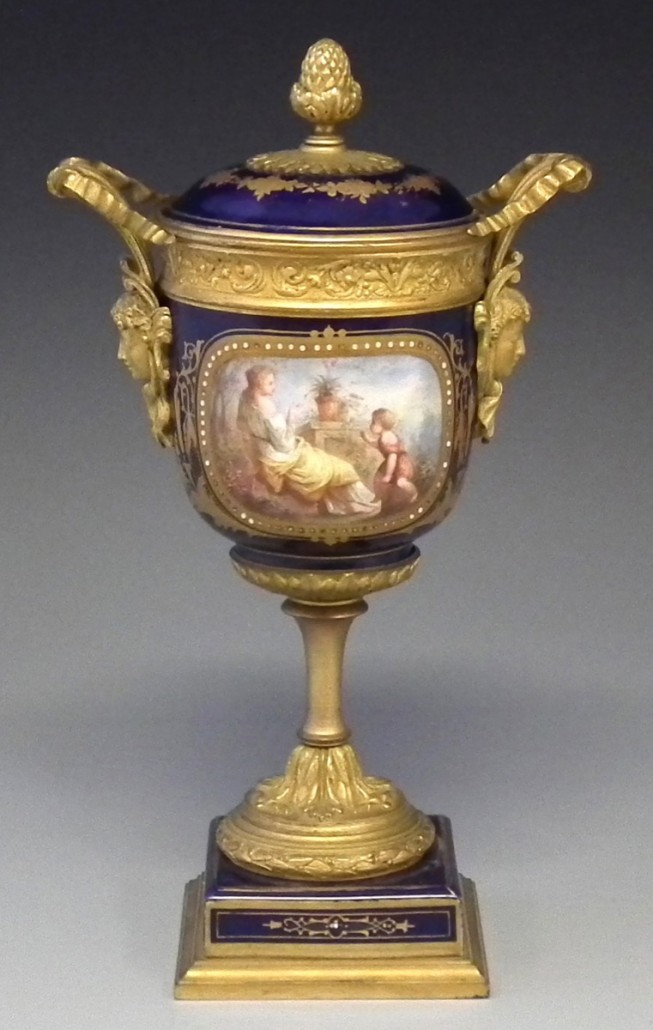 A 19th century Sèvres lidded vase with ormolu mounts painted with figures on a gilded and jeweled blue ground. It sold for £440. Photo Peter Wilson auctioneers
