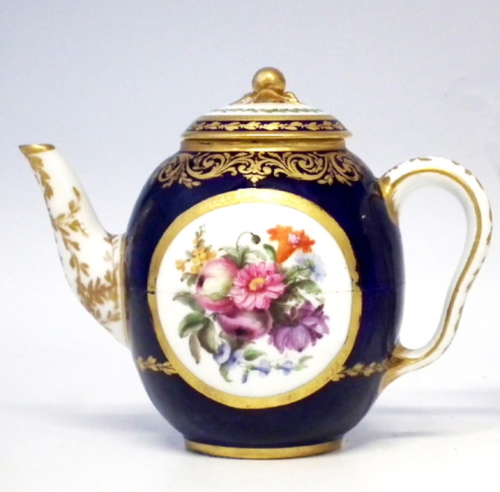 A good Sèvres teapot and cover, circa 1786, painted with floral sprays within gilt cartouches on a blue ground, with painted and gilded marks to its base. It sold for £300. Photo Peter Wilson auctioneers
