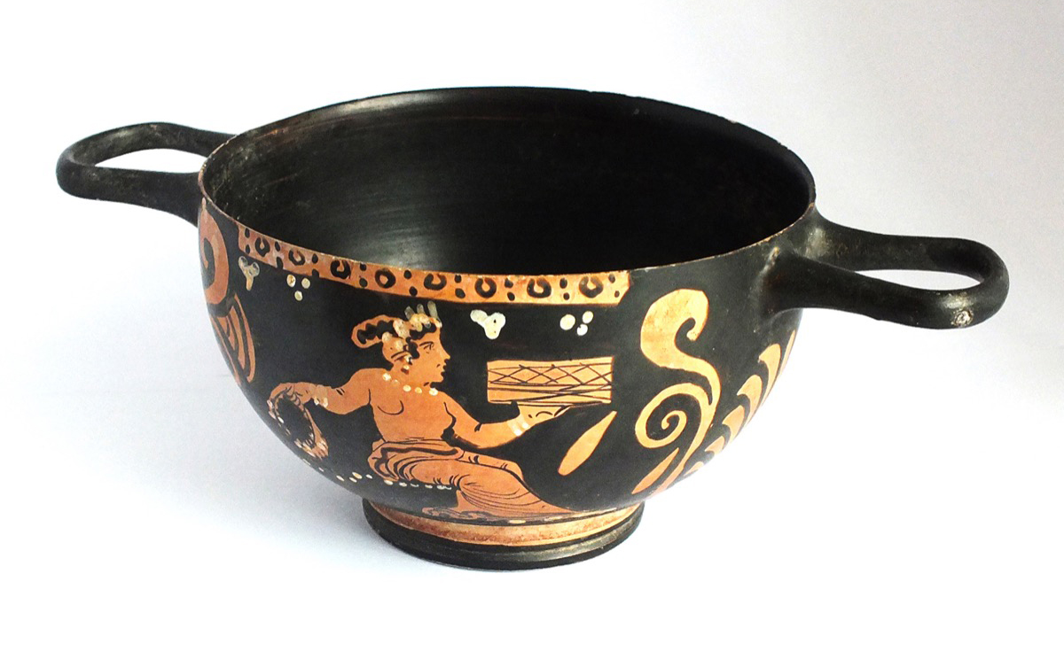 This ancient Greek wine cup is more than 2,300 years old and was made in Apulia, one of the Greek colonies in southern Italy in the 4th century BC. The twin-handled deep pottery cup is known as a bolsal and is decorated with a scantily clad female seated on a garland of flower heads. Photo Odyssey. 