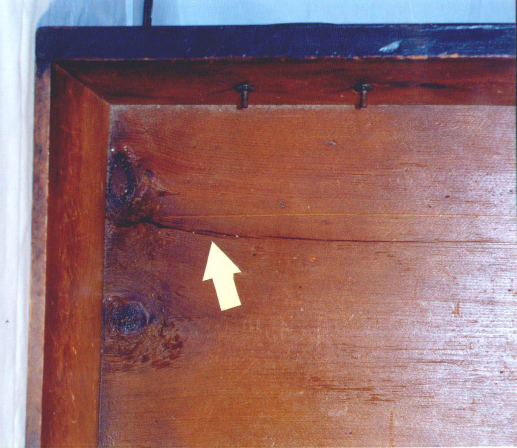 This ‘crack’ in the drawer bottom is caused by the wood shrinking across the grain. That means the bottom panel is improperly secured in the drawer, probably due to overenthusiastic restoration.