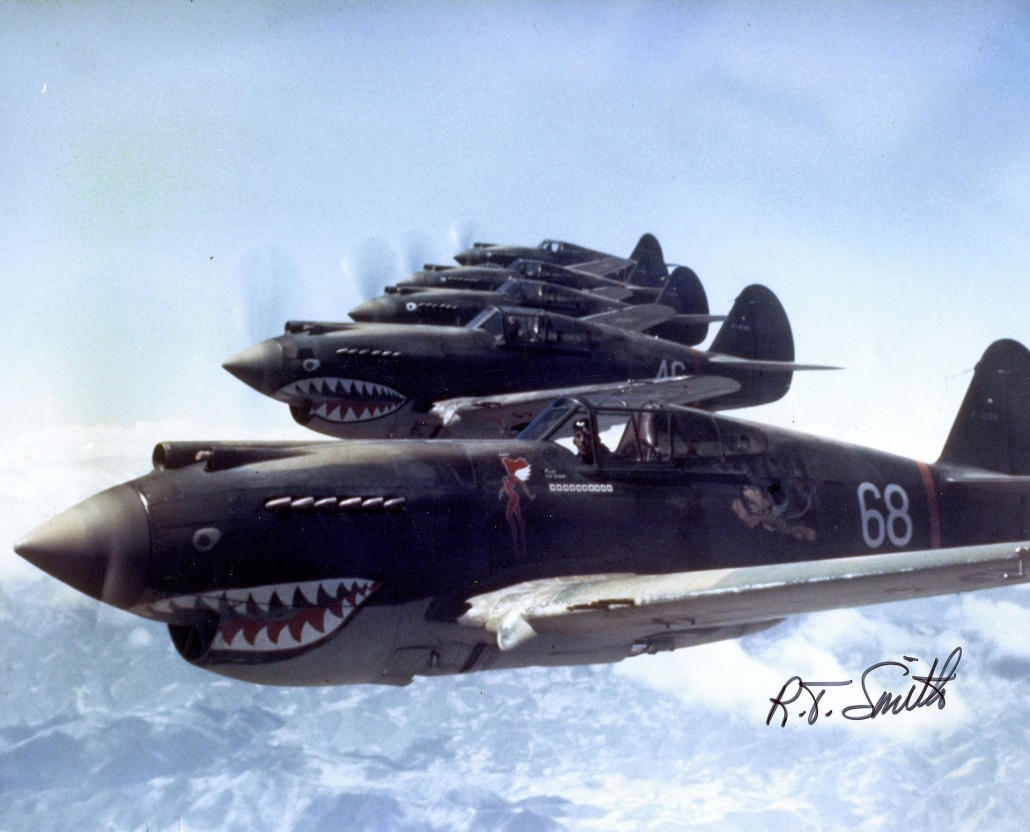This historical photo depicts the Flying Tigers' 3rd Squadron, known as 'Hell's Angels,' in flight over China. Photographed in 1942 by flight leader and ace fighter pilot Robert T. Smith. Public domain mage from San Diego Air and Space Museum Archive