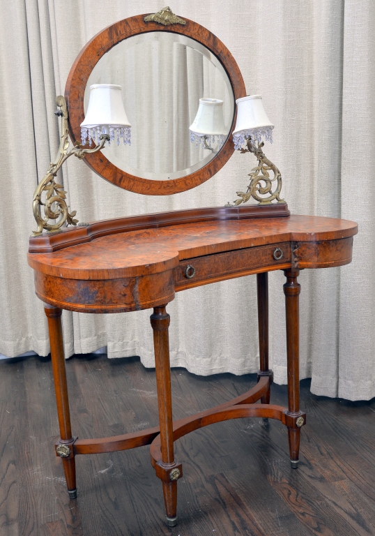 Kidney-shaped vanity with ormolu and side lamps. The Specialists of the South Inc. image