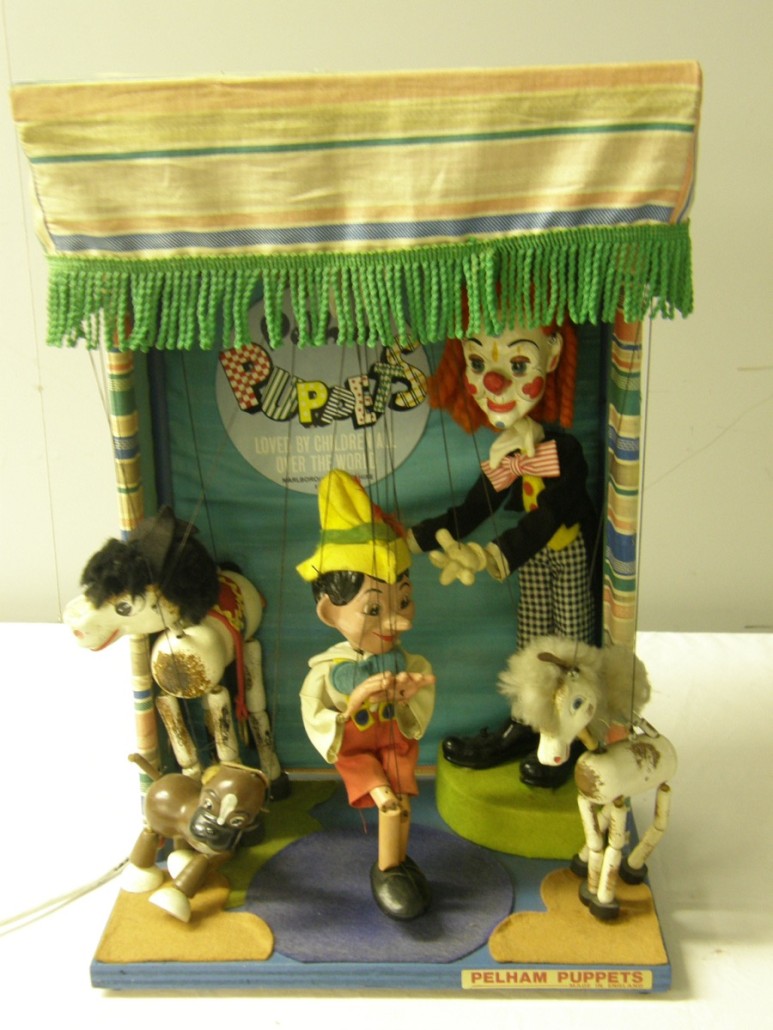 A battery-driven toyshop window animated display, the sign on the backdrop reading 'Pelham Puppets loved by children all over the world, Marlborough, Wiltshire, England.' The five puppets include Clown, Pinocchio, Horse, Dog and Pony. It sold for £160. Photo Ewbank’s auctioneers