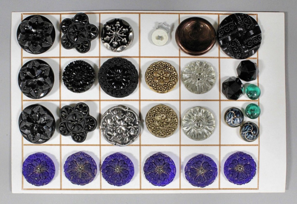 Nineteenth and 20th century buttons in clear, blue and black glass. They sold for £110. Photo The Canterbury Auction Galleries