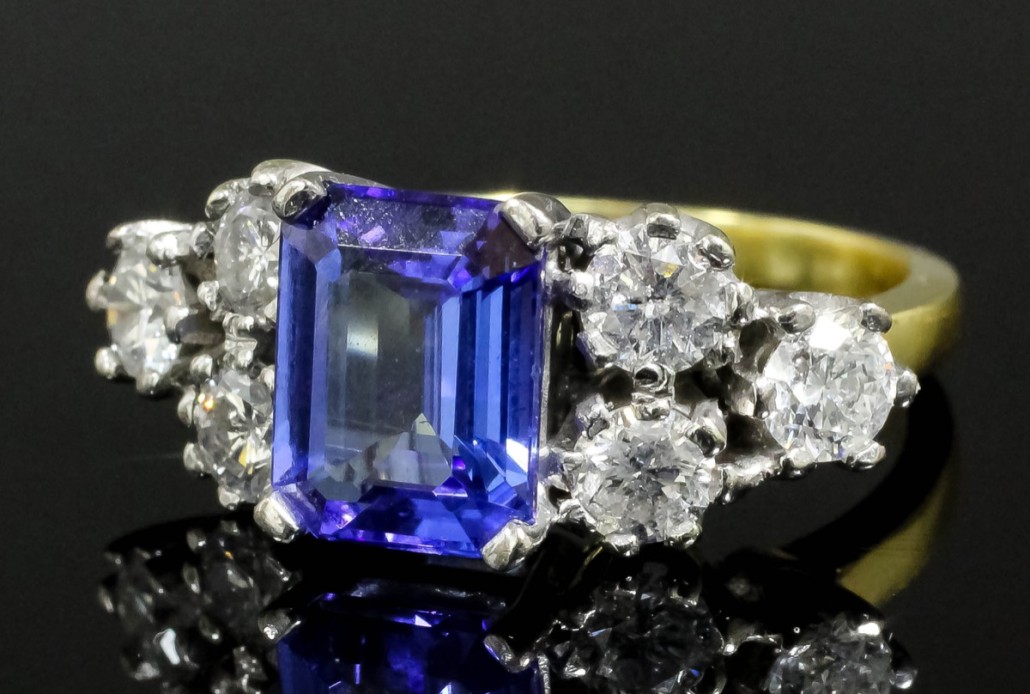 An 18K white and yellow gold dress ring, the square-cut tanzanite weighing approximately 2 carats, shouldered by three-brilliant cut diamonds. It sold for £1,600. Photo The Canterbury Auction Galleries