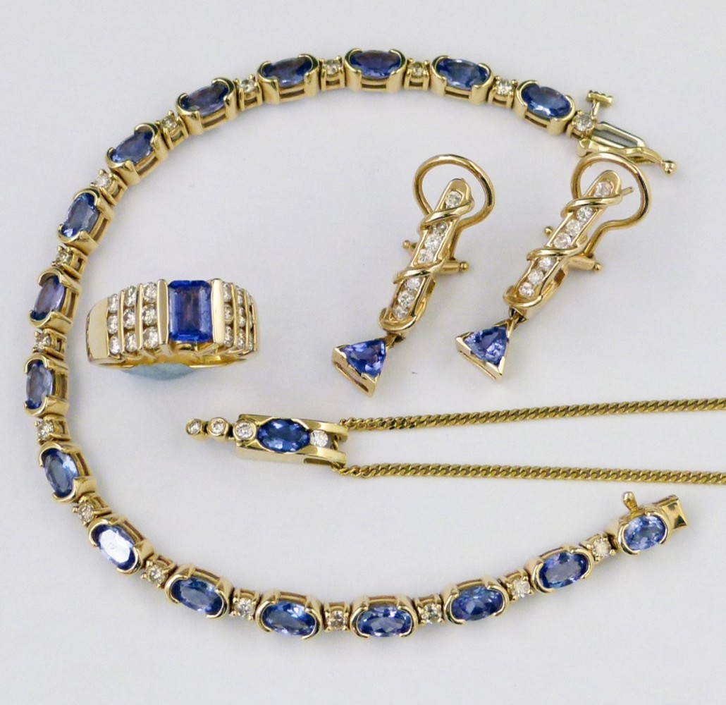 A suite of tanzanite jewellery comprising a line bracelet interspersed by point diamonds; a pair of drop earrings; a ring; and a pendant on a chain, all in 14ct gold, sold for £460. Photo Peter Wilson auctioneers 