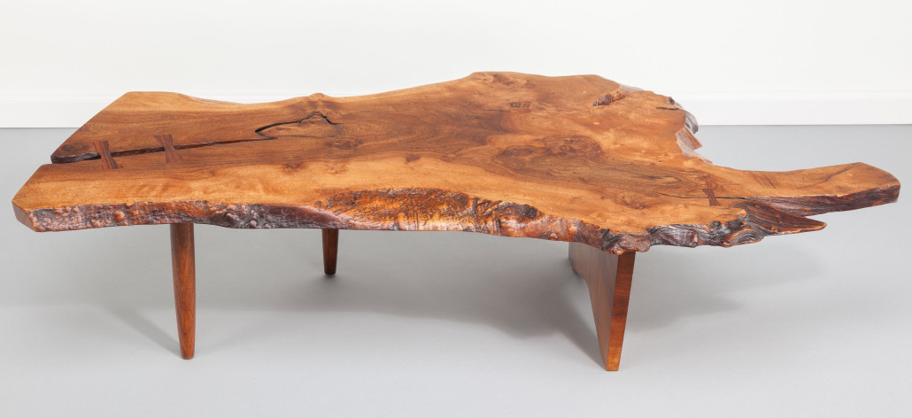 George Nakashima (American, 1905-1990), Conoid coffee table, circa 1975, English walnut with East Indian rosewood butterfly keys, 31 inches long. Estimate: $20,000-$30,000. Heritage auctions image