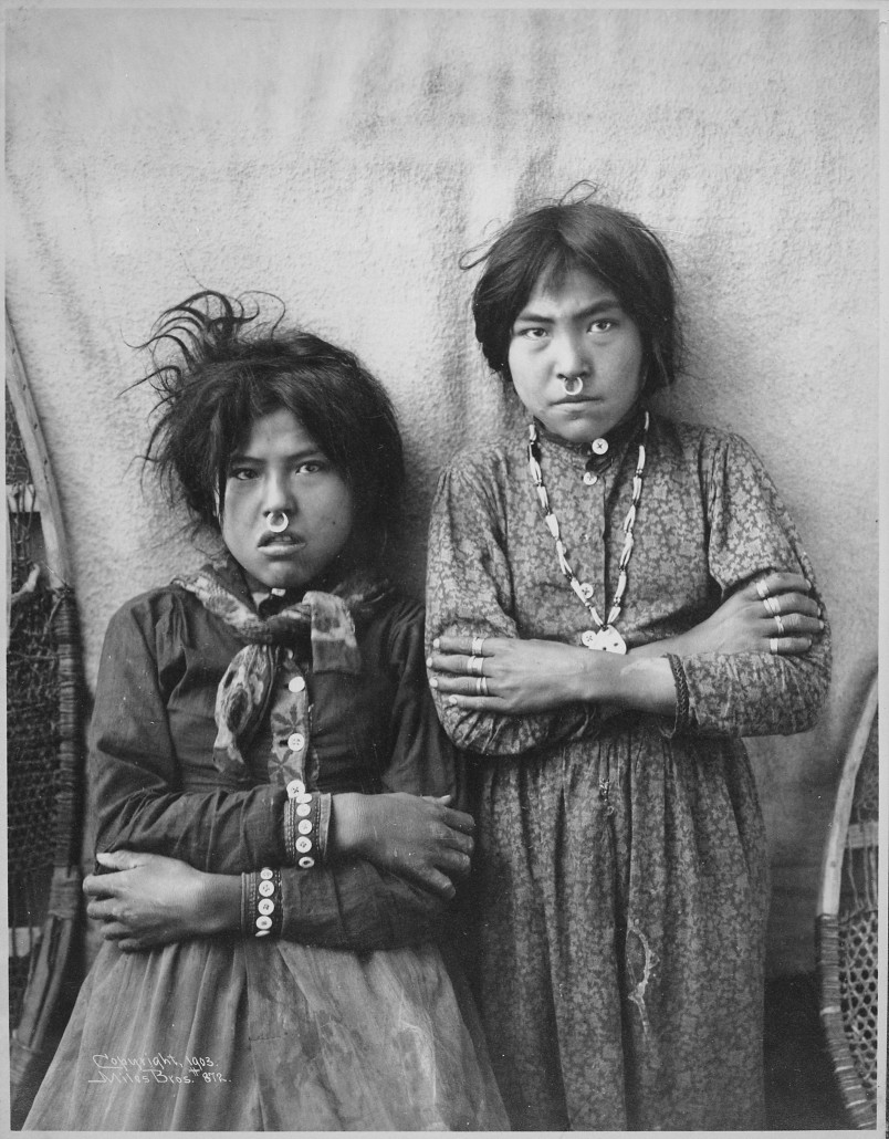 Two_Tlingit_girls,_Tsacotna_and_Natsanitna,_wearing_noserings,_near_Copper_River,_Alaska,_1903_-_NARA_-_524404_Image_courtesy_of_Wikimedia_Commons.