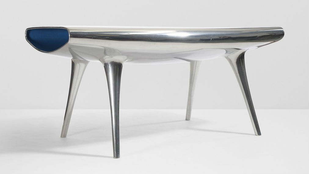 Marc Newson Event Horizon table, POD Edition, Australia, 1992, polished aluminum, enameled aluminum, 70.5in wide x 38in diameter x 32.25in high. Estimate: $200,000-$300,000. Wright image 