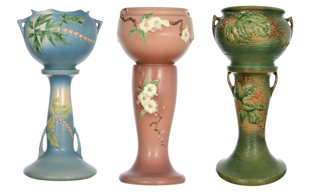 Roseville jardiniere and pedestal sets: Bleeding Heart, Apple Blossom and Bushberry. Woody Auction image