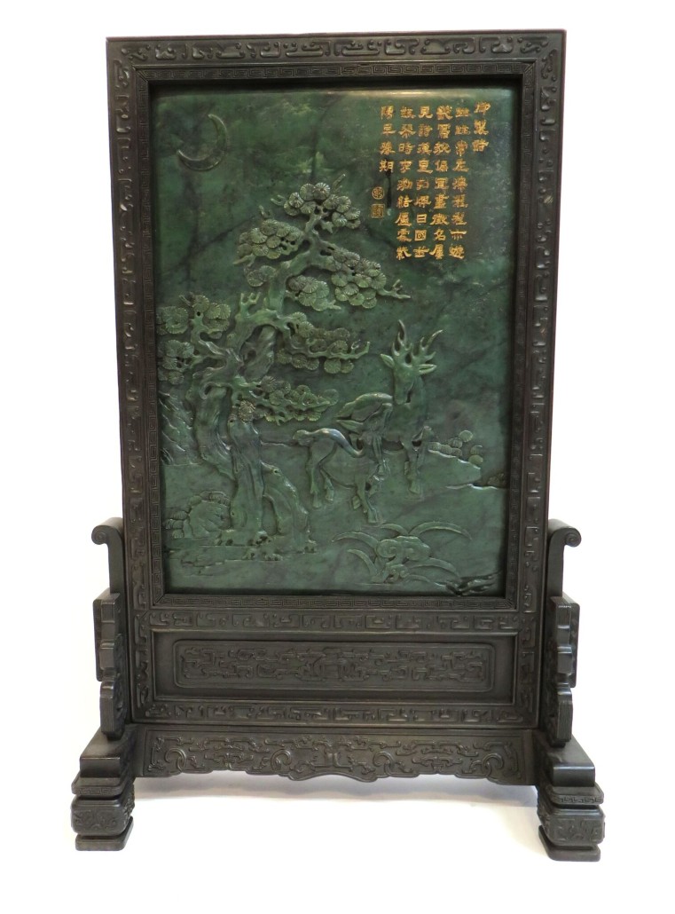 Chinese spinach jade screen carved in bas relief with deer in the forest, housed in a finely carved frame. Estimate: $8,000-$12,000. Converse & Co. image