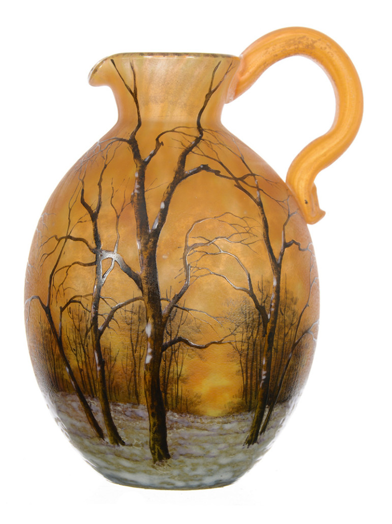 Signed Daum Nancy French cameo art glass handled pitcher, ovoid-shaped, with a rare winter scene décor, 5 3/4 inches tall. Estimate: $2,500-$4,000. Woody Auction image