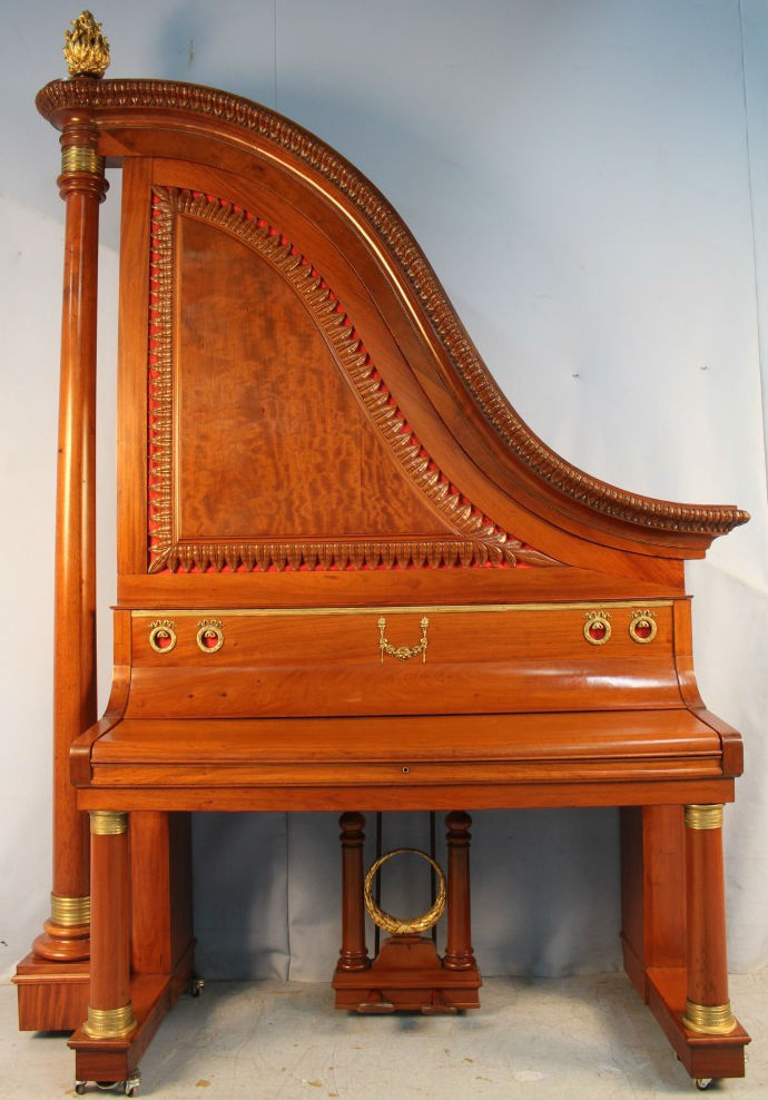 Late Victorian giraffe piano in a harp-form mahogany case. Stevens Auction Co. image
