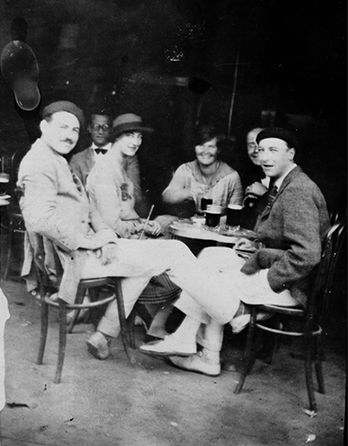 Ernest Hemingway (far left) with friends at a cafe in Pamplona, Spain, summer 1925. EH05734P. John F. Kennedy Presidential Library and Museum image