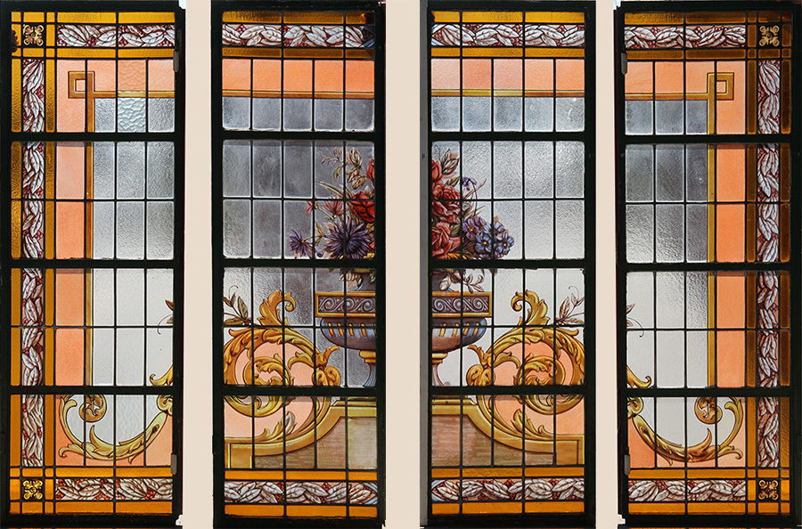 One of a pair of painted and leaded glass windows, each window comprised of four panels and having a central bouquet of flowers circa 1920, 58 inches high x 99 inches wide. Estimate: $800-$1,200. Kamelot Auction image 