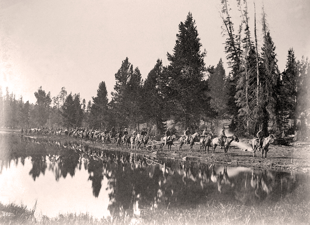 The U.S. Geological and Geophysical Survey of the Territories en route with pack train upon the trail between the Yellowstone and East Fork Rivers "showing the manner in which all parties traverse these wilds." Photo by William Henry Jackson. Image courtesy of Wikimedia Commons
