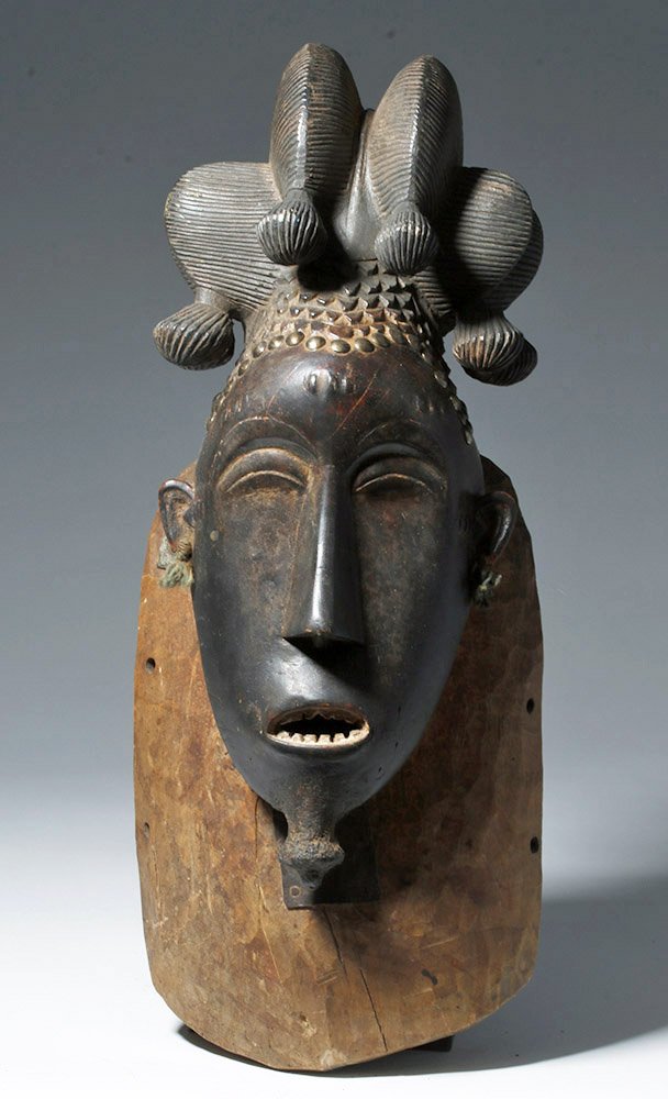 Elegant African carved wood Guro mask of the female deity Gu, early 20th century CE, est. $2,500-$5,000