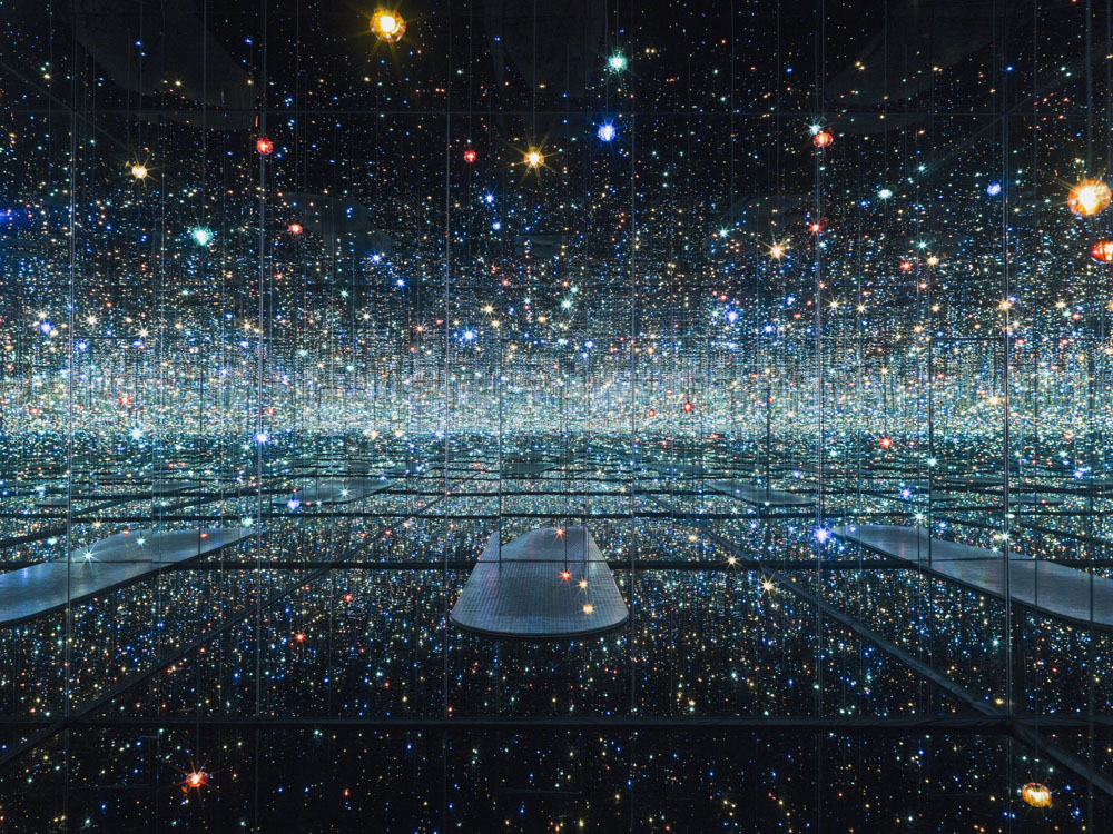 Yayoi Kusama, Infinity Mirrored Room – ‘The Souls of Millions of Light Years Away,’ 2013; wood, metal, glass mirrors, plastic, acrylic panel, rubber, LED lighting system, acrylic balls, and water, 113 1/4 x 163 1/2 x 163 1/2 in.; courtesy of David Zwirner, N.Y.; © Yayoi Kusama