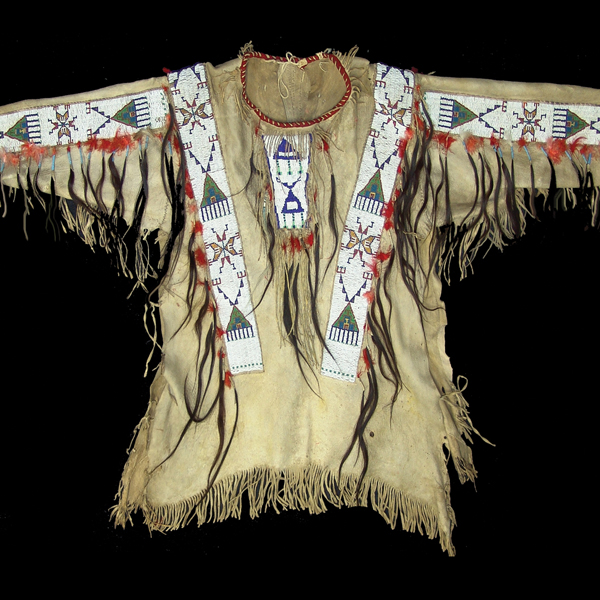 Circa 1900 traditional buckskin Teton Sioux beaded warrior's shirt with sinew sewn and lazy stitch beaded geometric panels and collar tabs (est. $25,000-$50,000). Allard Auctions Inc. image