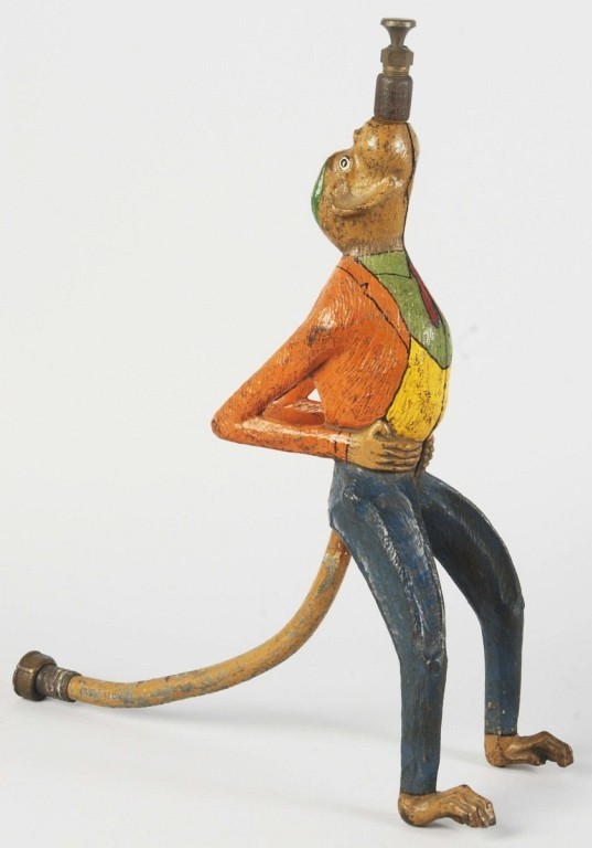Extremely rare monkey sprinkler depicting monkey standing upright, dressed in jacket with vest and pants. Sold for $7,500