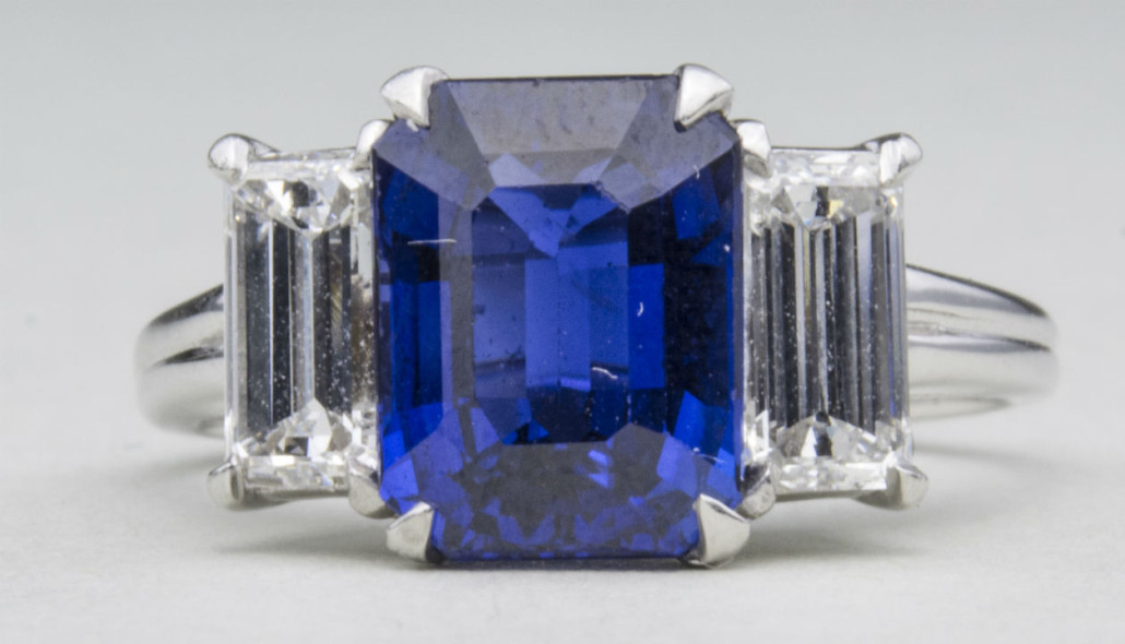 Oscar Heyman sapphire and diamond ring, platinum and 18K white gold ring with a center emerald cut sapphire. Sold for $10,800. Capo Auction image