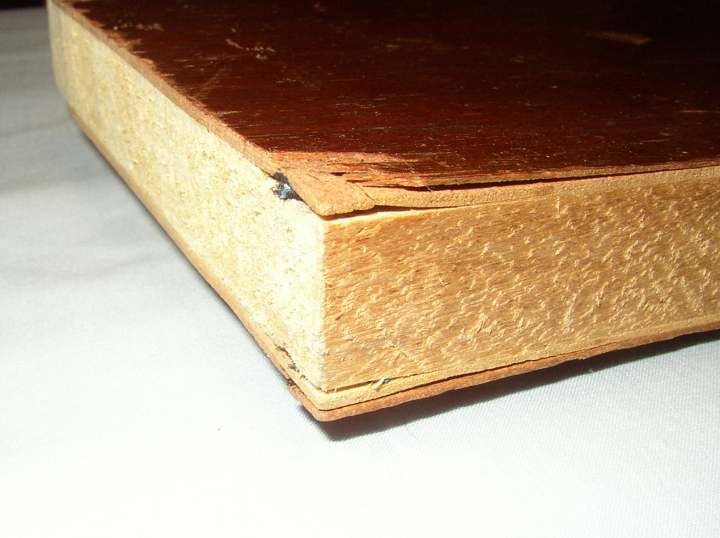 The five layers, solid core and four layers of veneer, of this lumber core plywood table leaf from the 1940s are easily visible once they are separated.