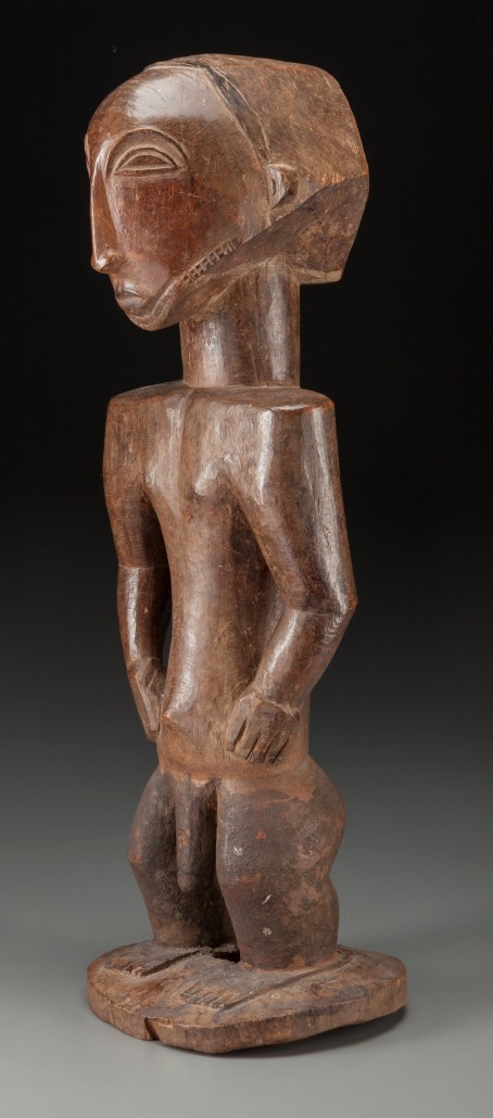 Carved wooden male figure. Hemba, Democratic Republic of Congo. 24 1/4 inches tall. Estimate: $8,000-$12,000. Heritage Auctions image