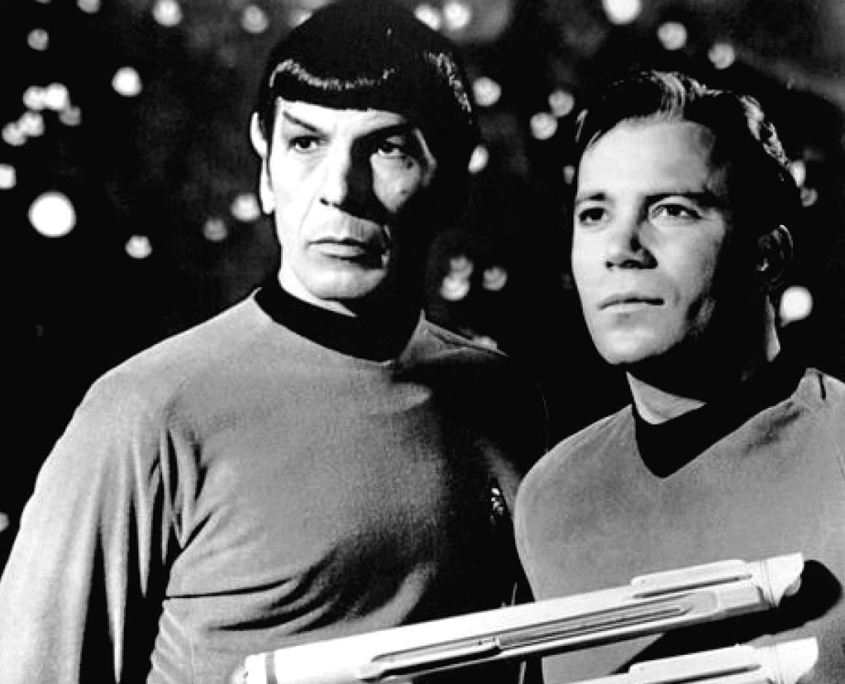 1968 publicity photo of Commander Spock (Leonard Nimoy) and Captain James T. Kirk (William Shatner) as they appeared in The Original Series. Public domain image
