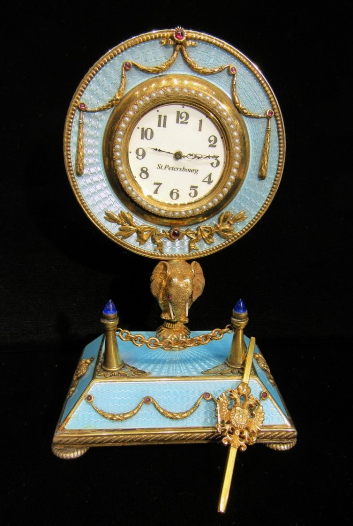 Fabergé-style silver gilt guilloche enamel key-wind desk watch and stand, 5 1/2 inches in height, with an elephant standing on the base with ruby eyes. Estimate: $2,000-$4,000. Converse Auctions image