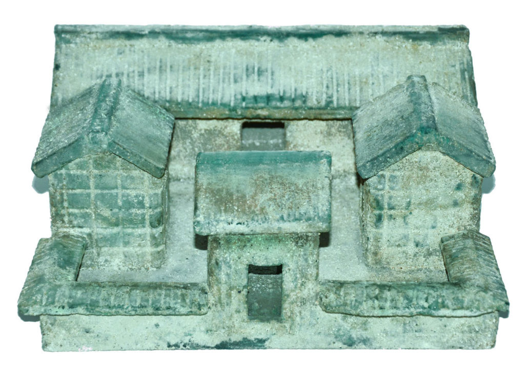 Eastern Han blue-glass model of a courtyard surrounded by four buildings with a front entrance. 12-inches wide by 5 inches-tall., $400,000-$500,000. Gianguan Auctions image