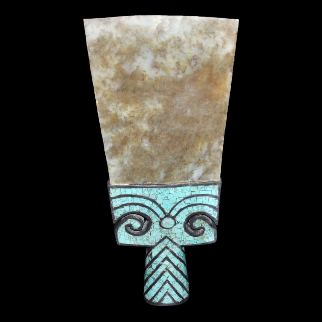 Neolithic Ouija ritual jade spade with 14-inch blade of greenish white jade. The handle is inlaid with turquoise tesserae in the form of a taotie mask. Estimate: $50,000-$80,000. Gianguan Auctions image