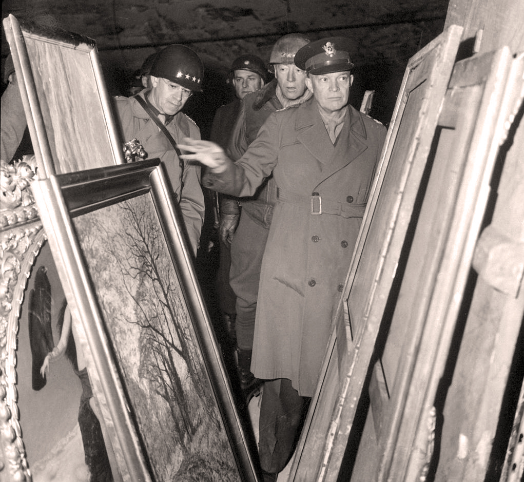 Gen. Dwight D. Eisenhower inspects stolen artwork in a salt mine in Merkers, Germany, accompanied by Gen. Omar Bradley (left) and Gen. George S. Patton (center). National Archives image courtesy Wikimedia Commons