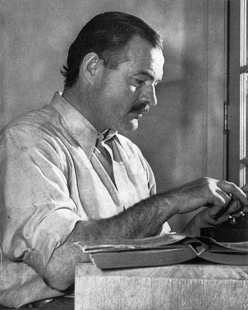 1939 photo of Ernest Hemingway posing for a dust jacket photo taken by Lloyd Arnold for the first edition of ‘For Whom the Bell Tolls,’ taken at the Sun Valley Lodge, Idaho. Public domain image 