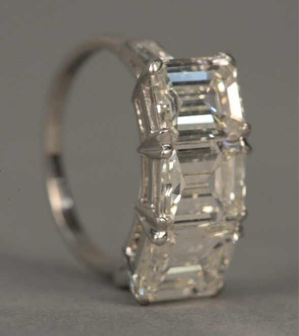 Platinum ring set with three emerald-cut diamonds, each approximately 1.8 to 1.9 carats, sold for $37,200