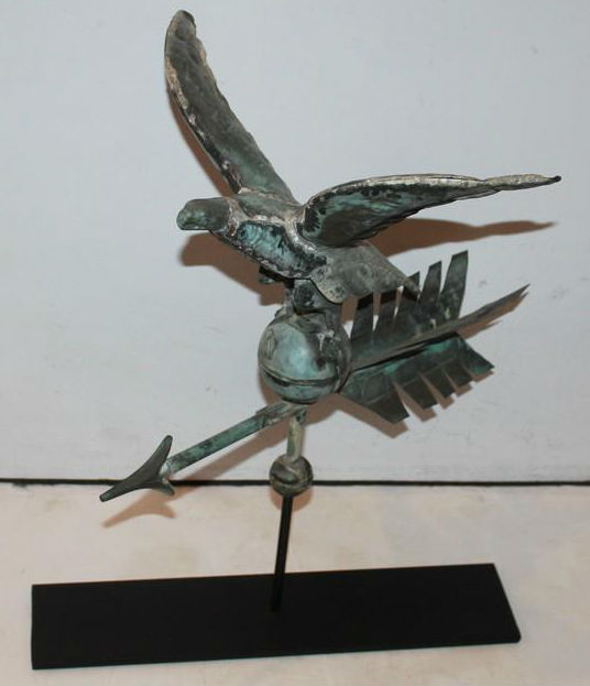Diminutive eagle full-body weather vane on stand, 1880-1890, 22 inches high x 19 inches wide x 15 inches deep. Estimate: $1,675-$3,850. Jasper52 image