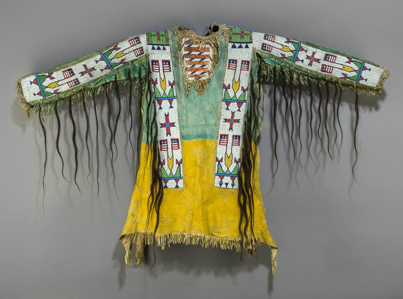 Decorated with locks of hair, this Sioux pictorial beaded hide war shirt sold for $32,500. Heritage Auctions image