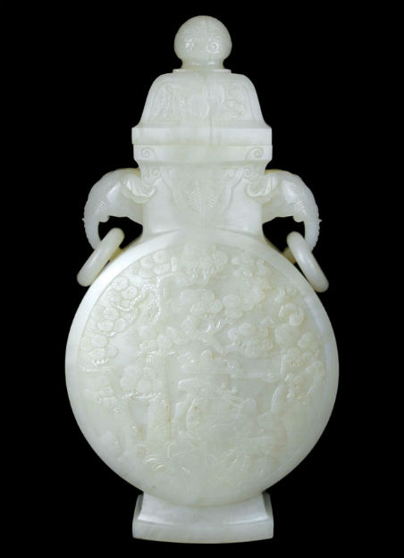 An elaborately carved white jade moon flask with cover and elephant head handles with rings. 13 inches high. Gianguan Auctions image