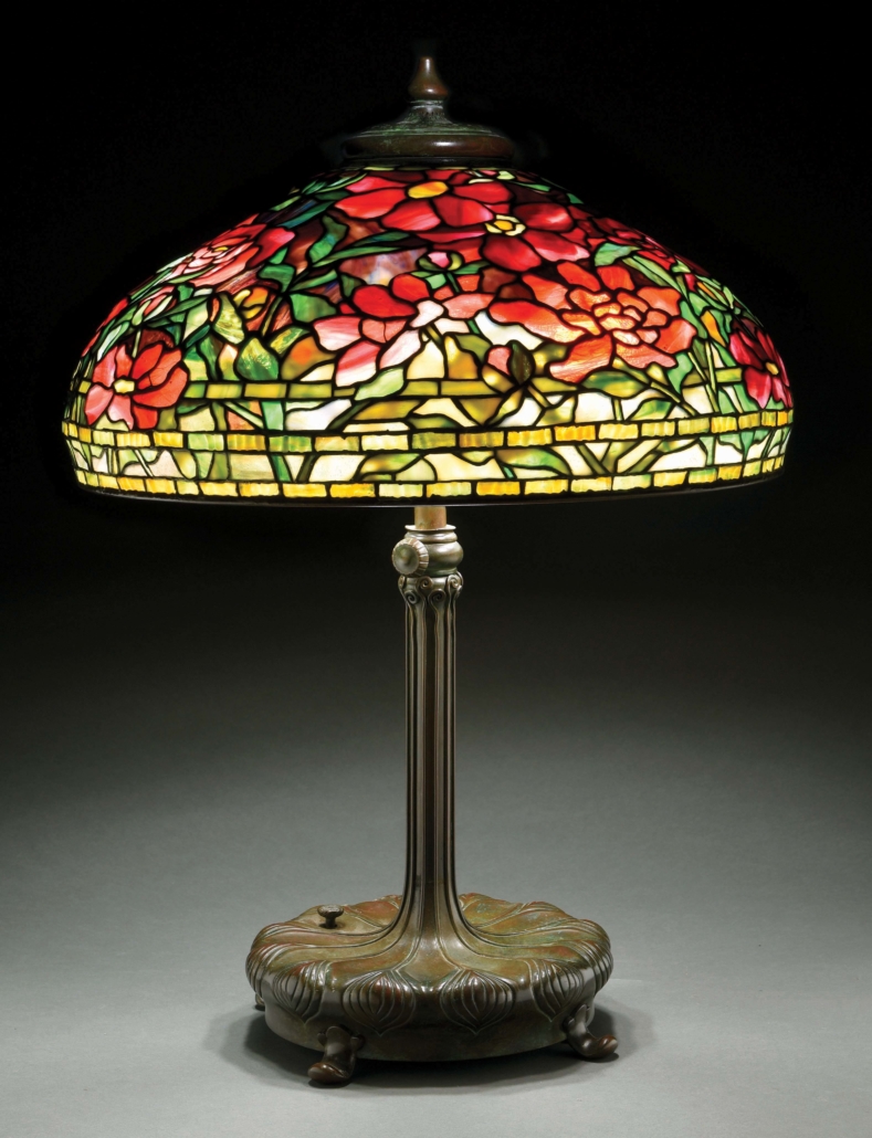 Circa-1910 Tiffany Studios ‘Peony’ leaded-glass table lamp, both 22in shade and telescopic, six-socket ‘Chased Pod’ base are signed. Excellent condition. Estimate $100,000-$150,000
