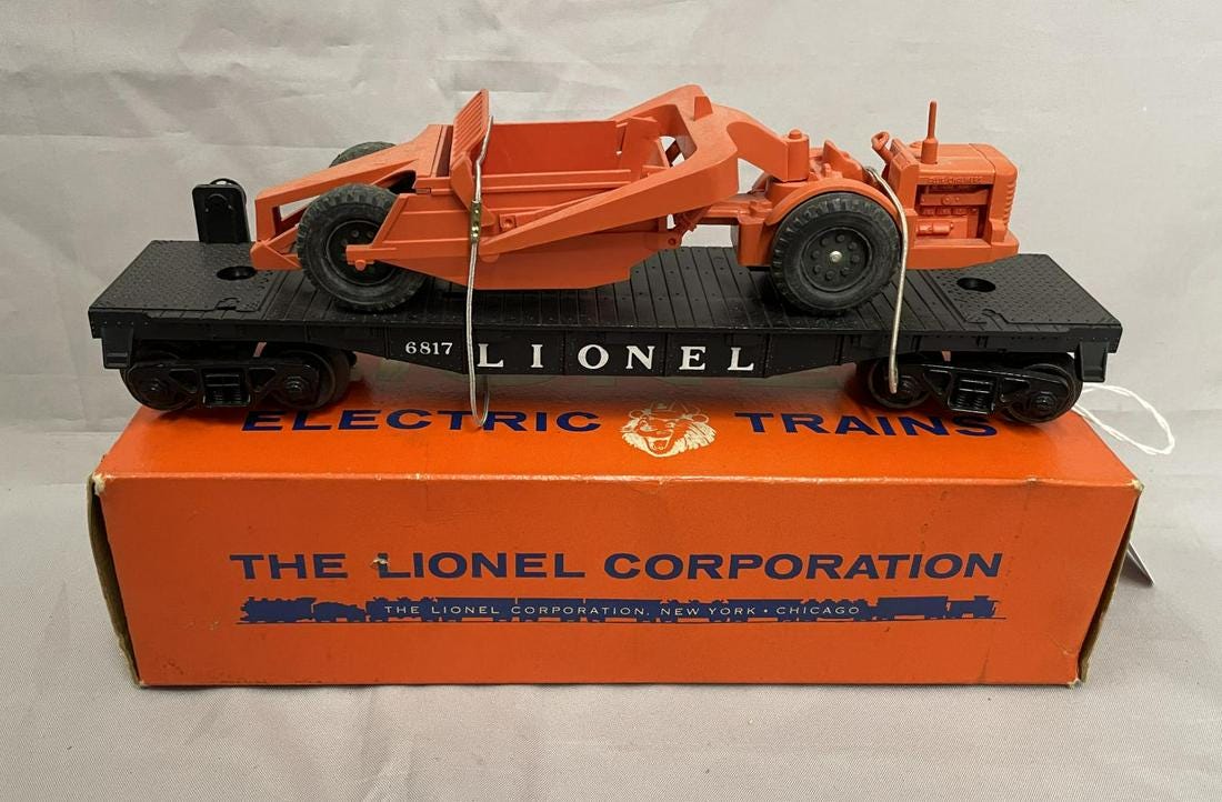 Lionel no. 6817 black flatcar and earth mover with Allis-Chalmers unit, $3,360. Image courtesy Weiss Auctions and Live Auctioneers.