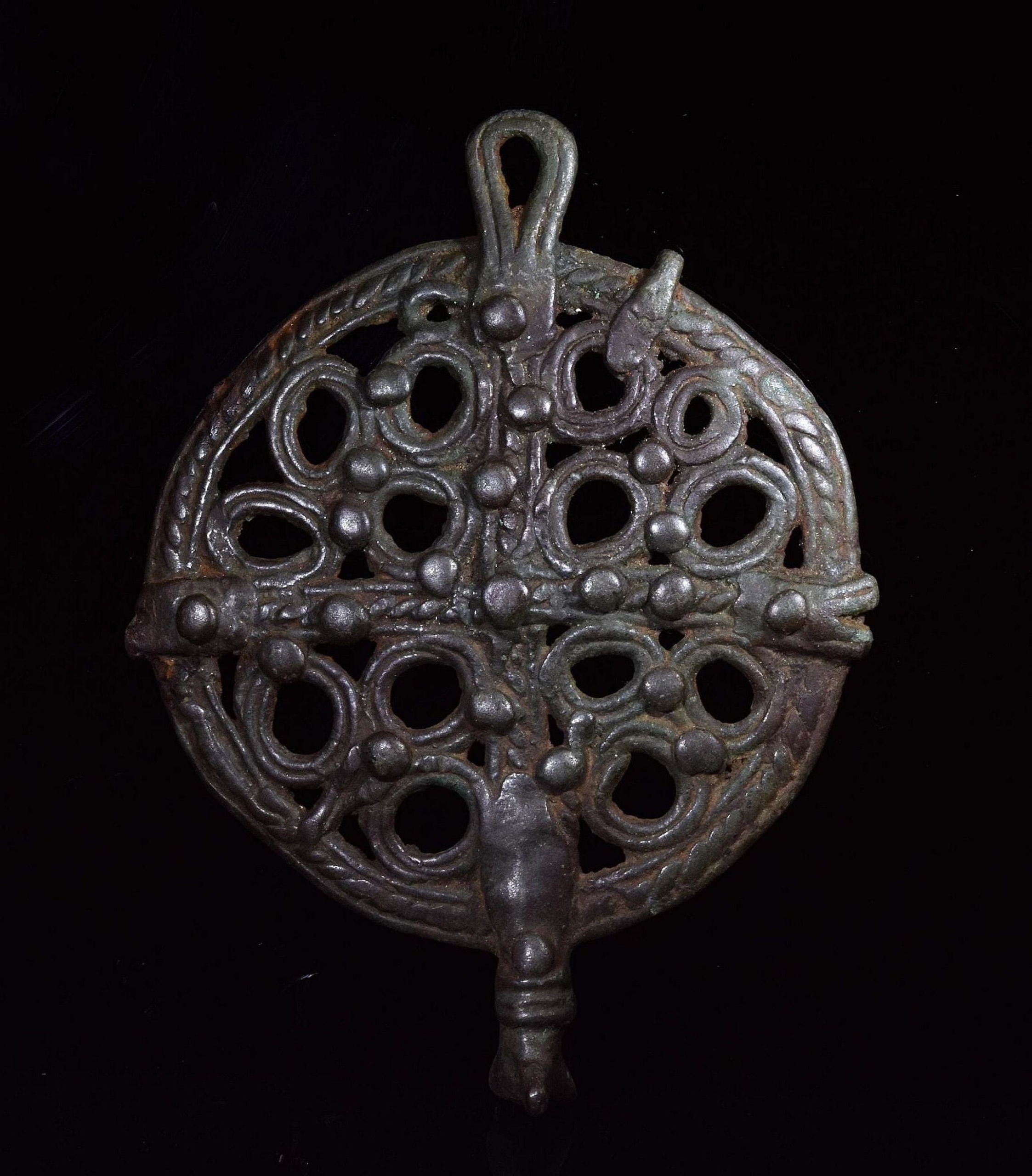 Bronze Age circular pendant in ornamental cross-in-circle design, 99mm x 75mm, 54g. , C. 800-600 BC. Realized £140 2020 Image courtesy of Pax Romana Auctions and LiveAuctioneers.