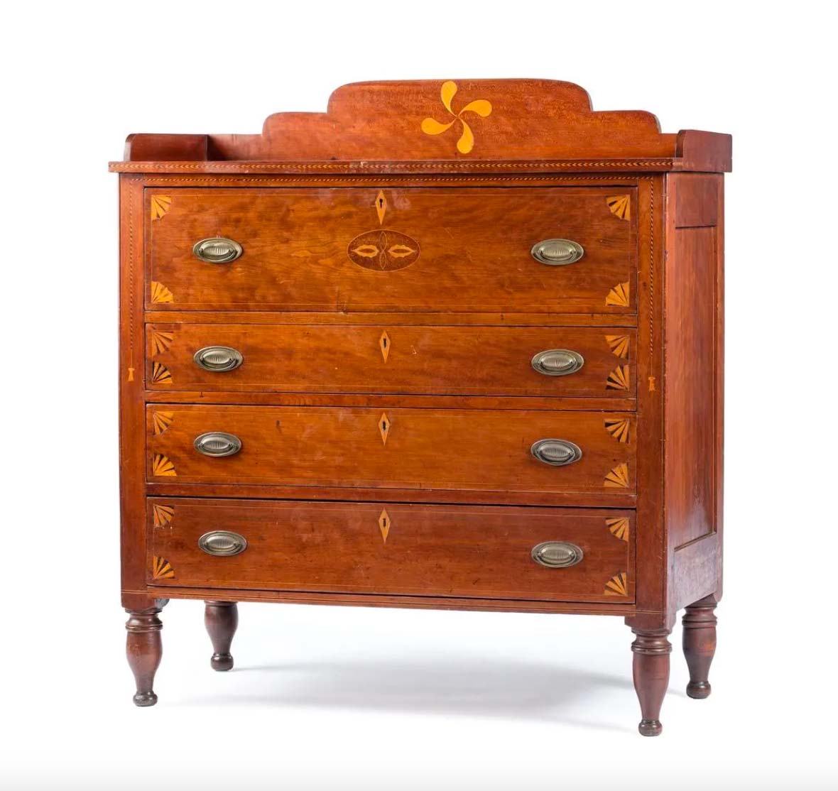 Federal fan and fylfot inlaid cherrywood chest of drawers, circa 1840, $15,360. Image courtesy Cowan's and LiveAuctioneers.com