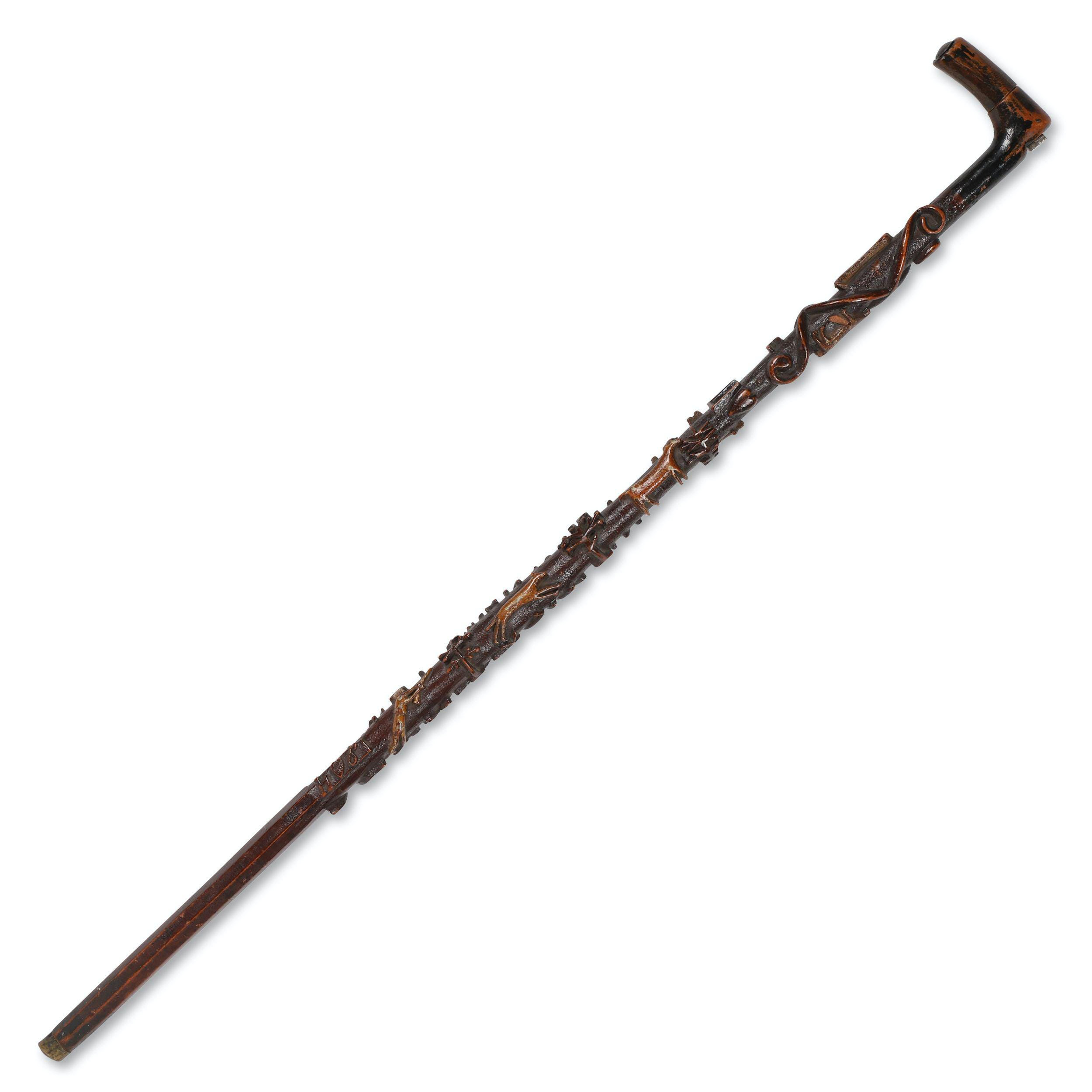 Allegorical walking stick with carved details, circa 1870-1880, estimated at $3,000-$5,000.