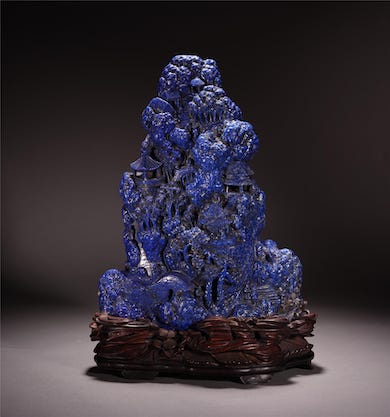 This extensively carved Chinese lapis scholar’s rock on a rosewood stand brought $20,000 plus the buyer’s premium in May 2020 at Bridgewater Auction.