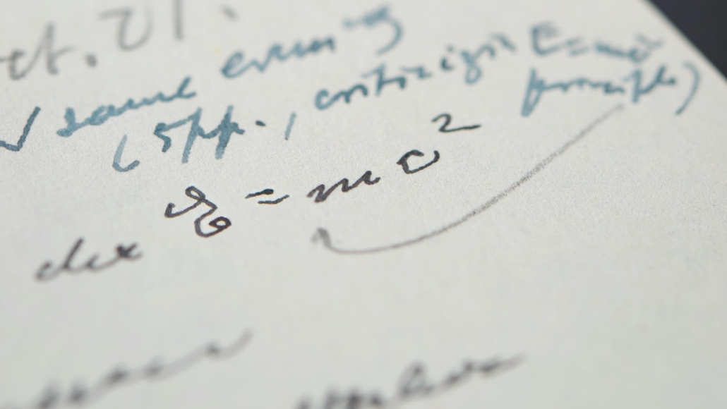 Detail showing the equation in Einstein’s handwriting; the letter is in German.